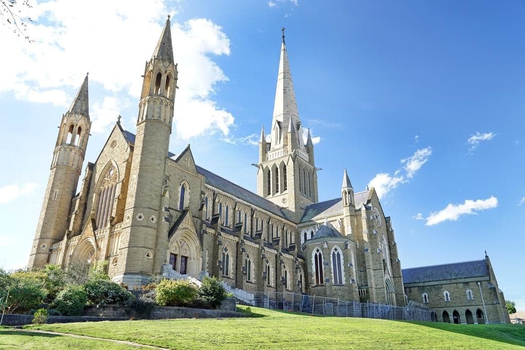 a clock tower with a flag on top of it