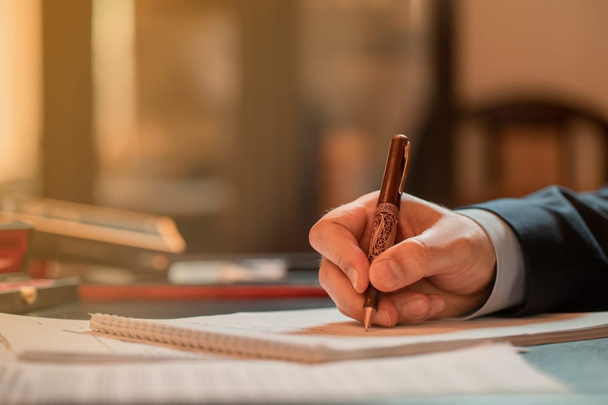 Person writing with a pen