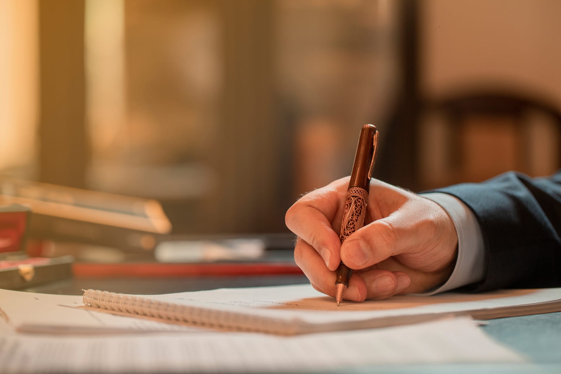 Person writing with a pen