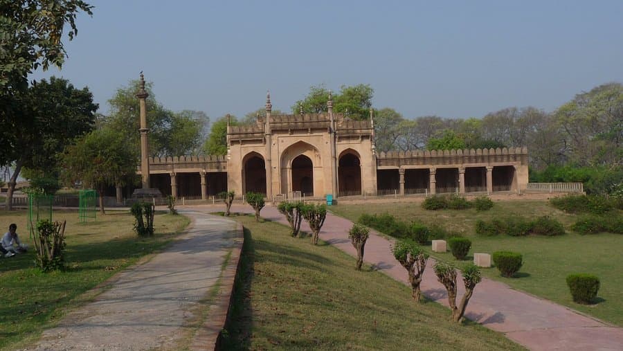 a brick wall with writing on it in front of a building